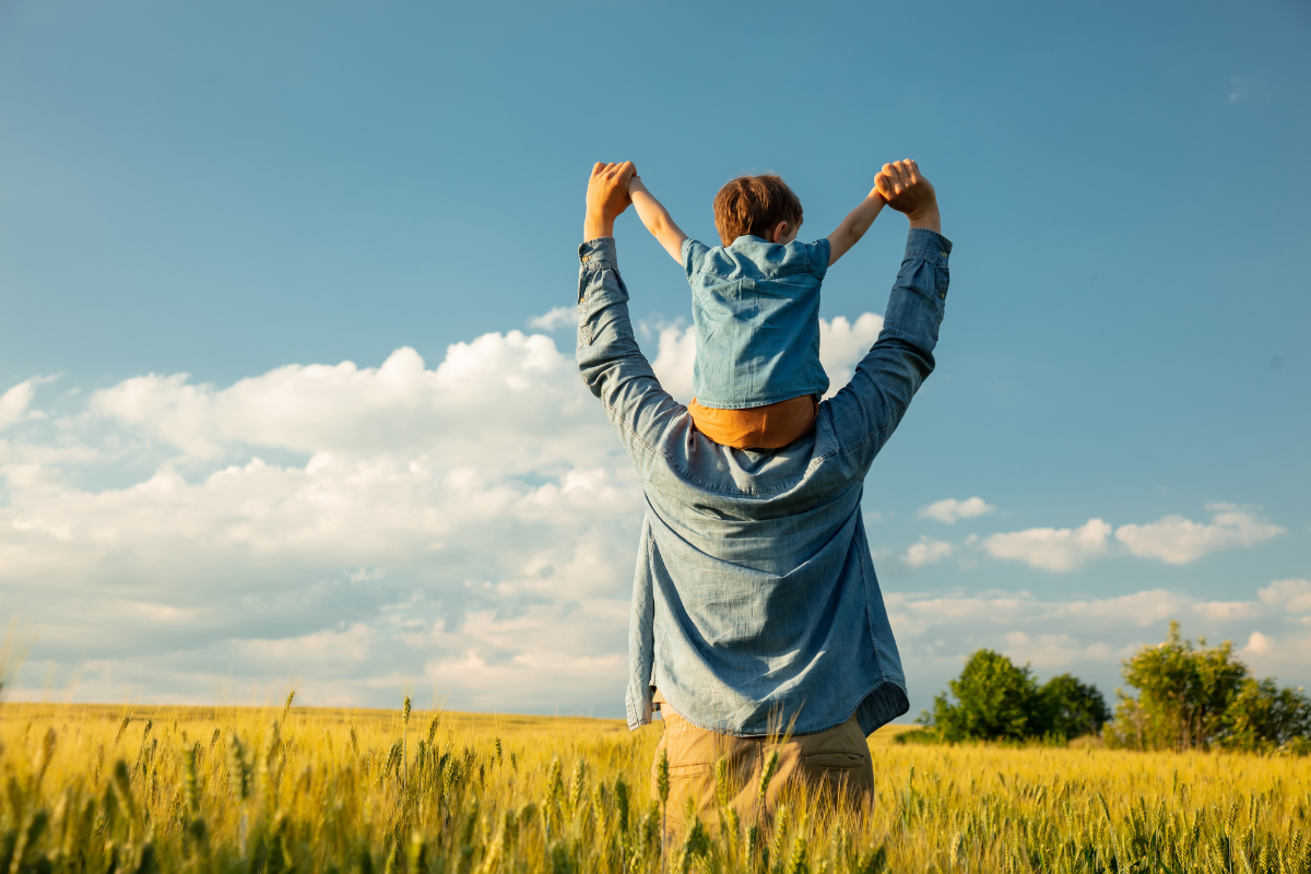 Child Sitting on His Father's Shoulders in a Wheat Field View more by Masson free for Canva Teams